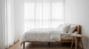  small bedroom with tall sheer curtains creating height